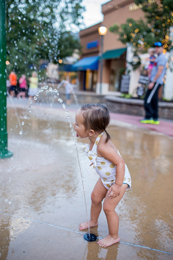 Girl playing in fountain