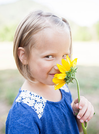 Girl smelling a flower